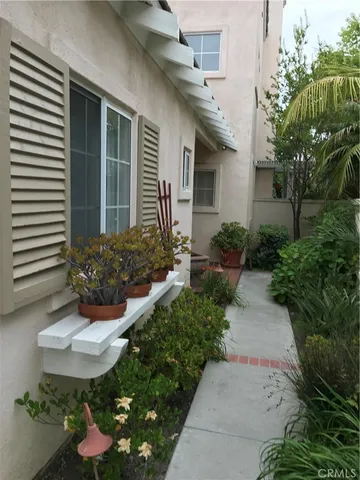 a view of a house with a small window and flower pot