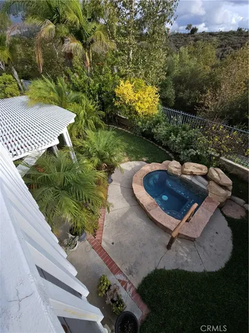 an aerial view of a backyard with swimming pool