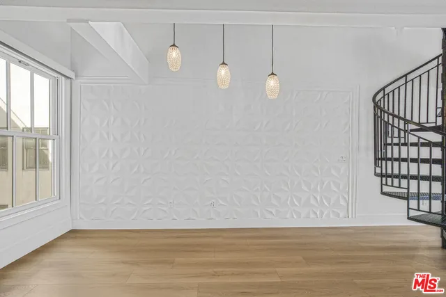 a view of a room with wooden floor and window