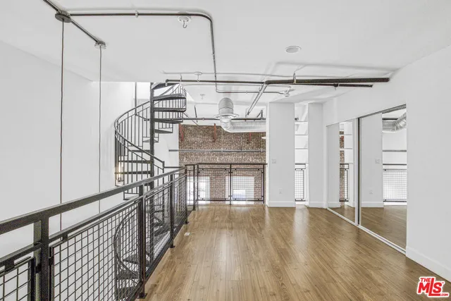 a view of entryway with stairs and wooden floor