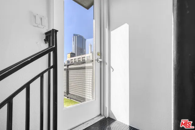 a view of staircase with railing and white walls