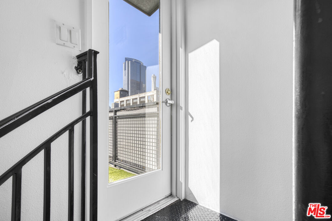 253 South Broadway, Unit 507 Los Angeles, CA 90012 - Photo 21 of 33 a view of a hallway with wooden floor and staircase