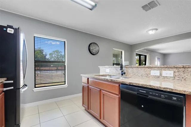 a kitchen with stainless steel appliances granite countertop a sink stove and cabinets
