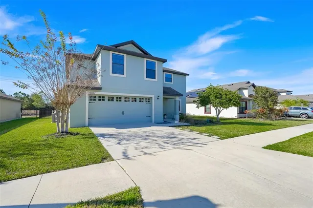 a front view of a house with a yard and garage