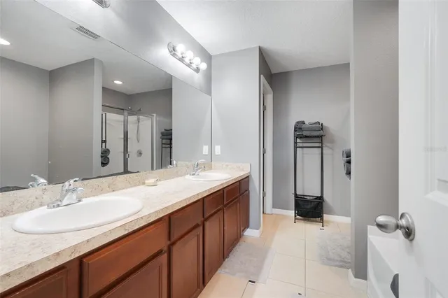 a bathroom with a double vanity sink and mirror