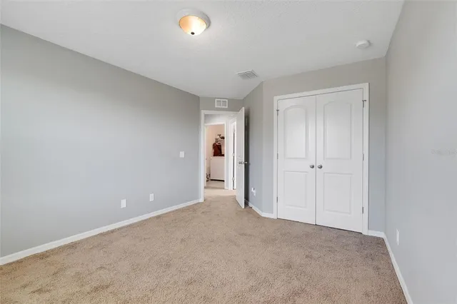 a view of an empty room and closet