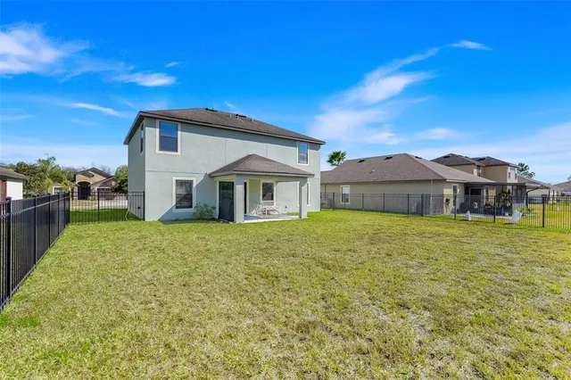 a view of a swimming pool with a yard