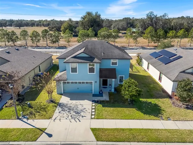 a view of a house with a yard and pool