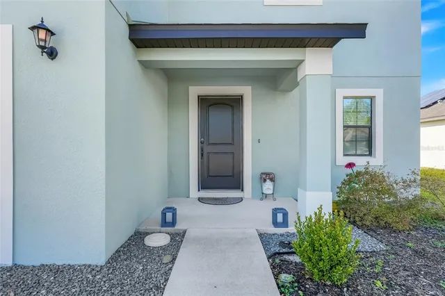 a hallway with flowers and a table