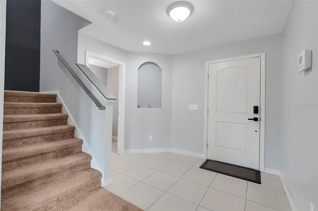 a view of entryway with stairs and a rug