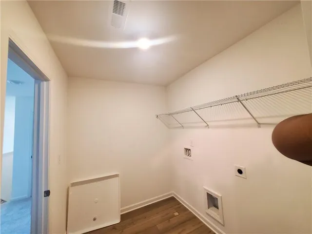 a view of a room with wooden floor