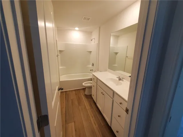 a bathroom with a sink a mirror and a shower