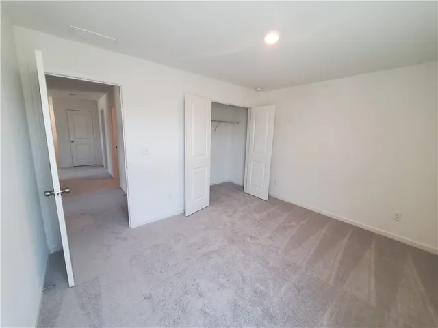a view of an empty room and closet area
