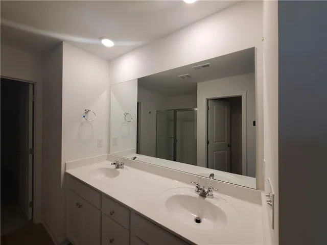 a bathroom with a sink vanity and a mirror