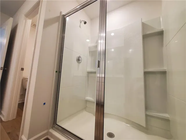 a bathroom with a glass door shower