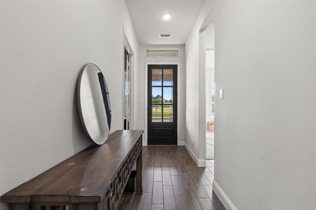 8808 Royal Star Road Rowlett, TX 75089 - Photo 14 of 40 a view of a hallway with wooden floor and entryway