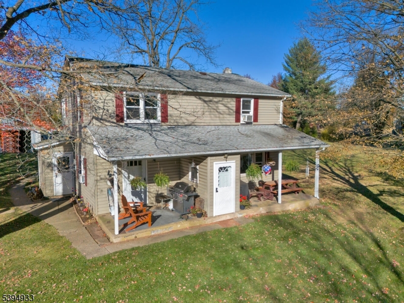 58 Dunkard Church Road Stockton, NJ 08559 - Photo 23 of 26 a view of a patio with table and chairs under an umbrella