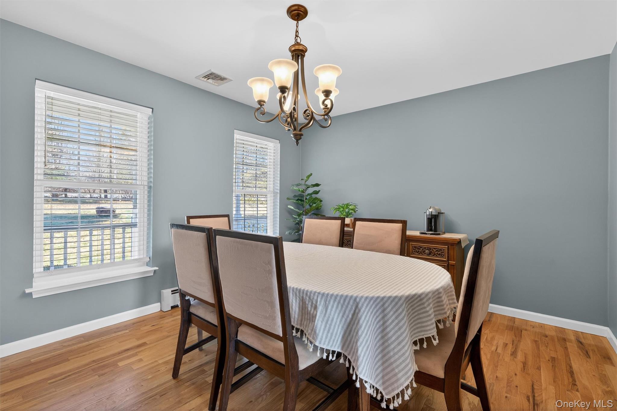 127 Egbertson Road Campbell Hall, NY 10916 - Photo 12 of 48 a view of a dining room with furniture a chandelier and wooden floor