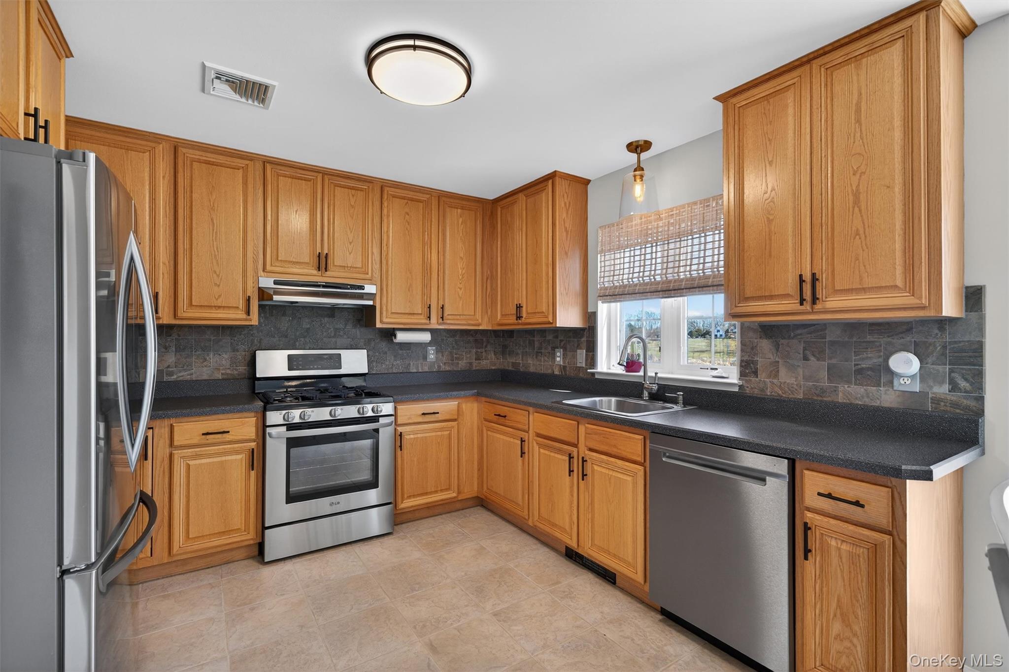 127 Egbertson Road Campbell Hall, NY 10916 - Photo 19 of 48 a kitchen with stainless steel appliances granite countertop a stove a sink dishwasher and a refrigerator