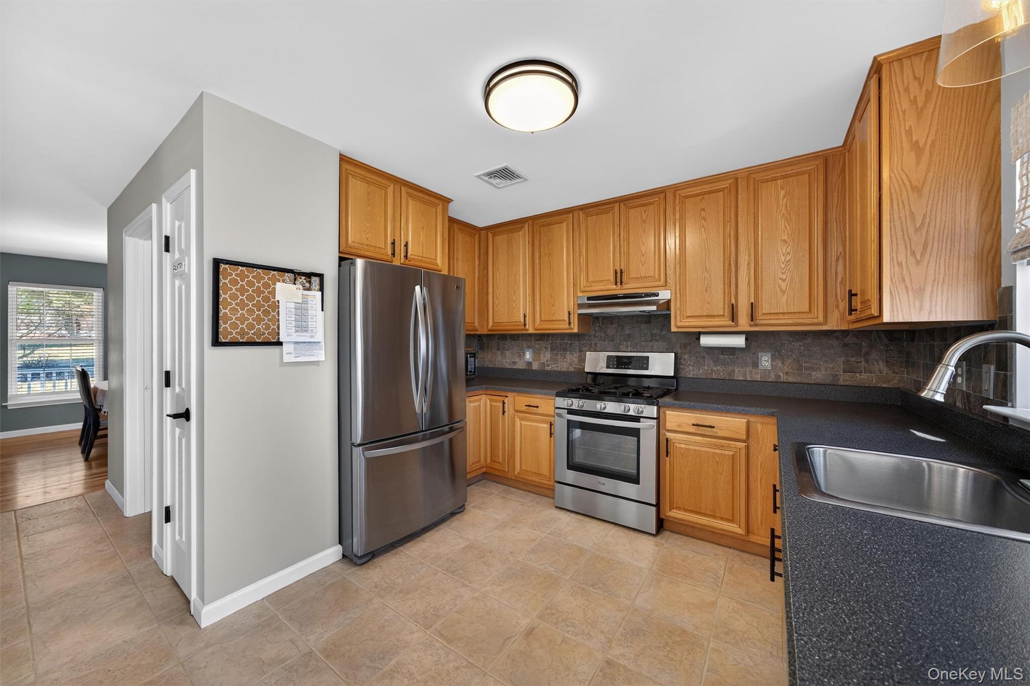 127 Egbertson Road Campbell Hall, NY 10916 - Photo 20 of 48 a kitchen with stainless steel appliances granite countertop a refrigerator stove top oven and sink