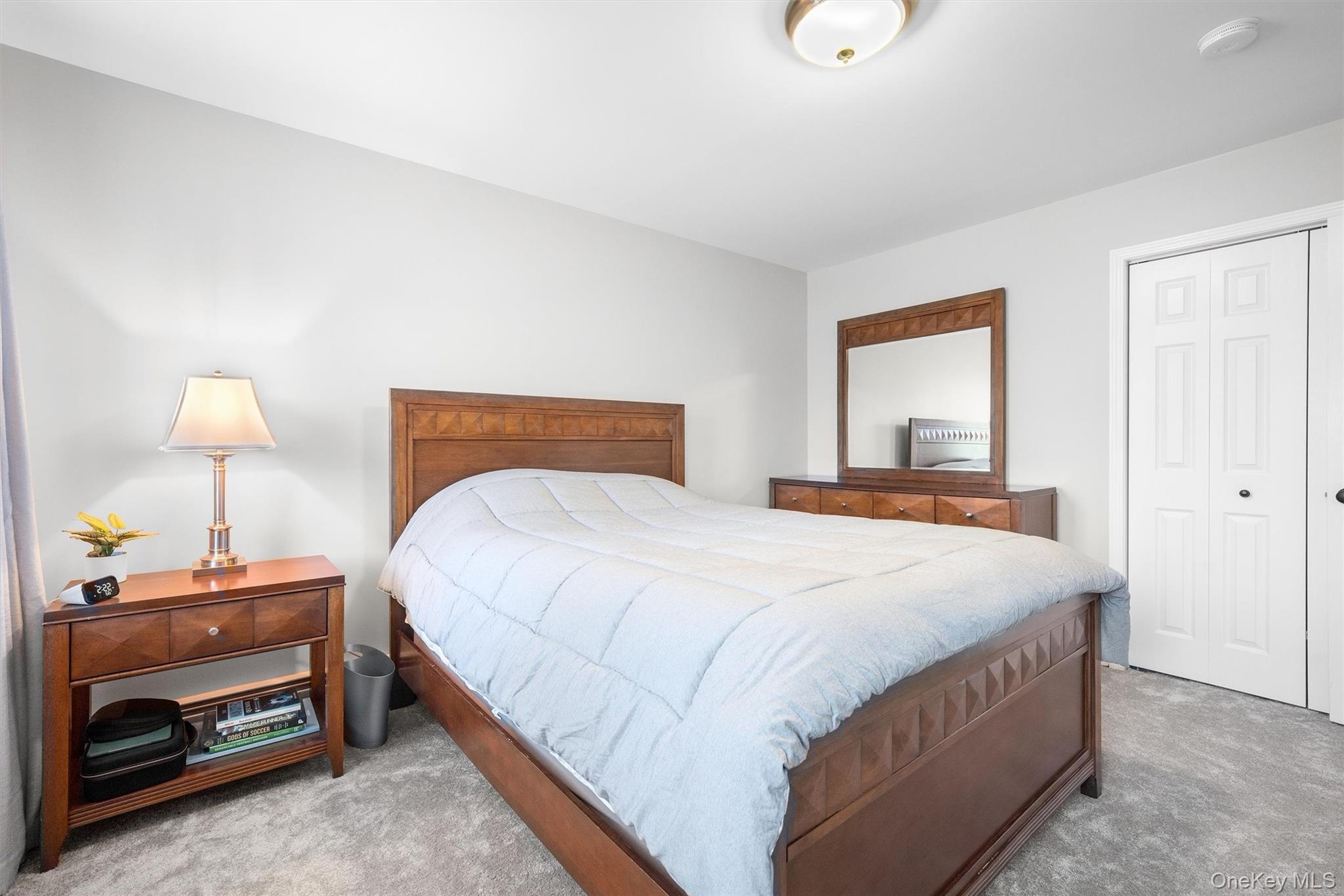127 Egbertson Road Campbell Hall, NY 10916 - Photo 31 of 48 a bedroom with a bed and a lamp
