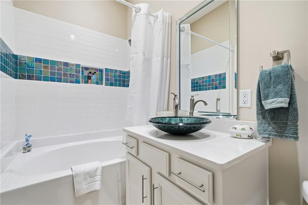 608 Red Leaf Way Canton, GA 30114 - Photo 32 of 43 a bathroom with a sink and a mirror