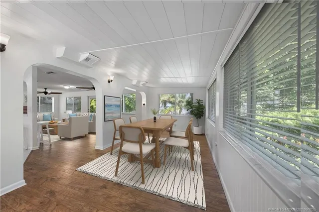 a dining room with furniture and wooden floor