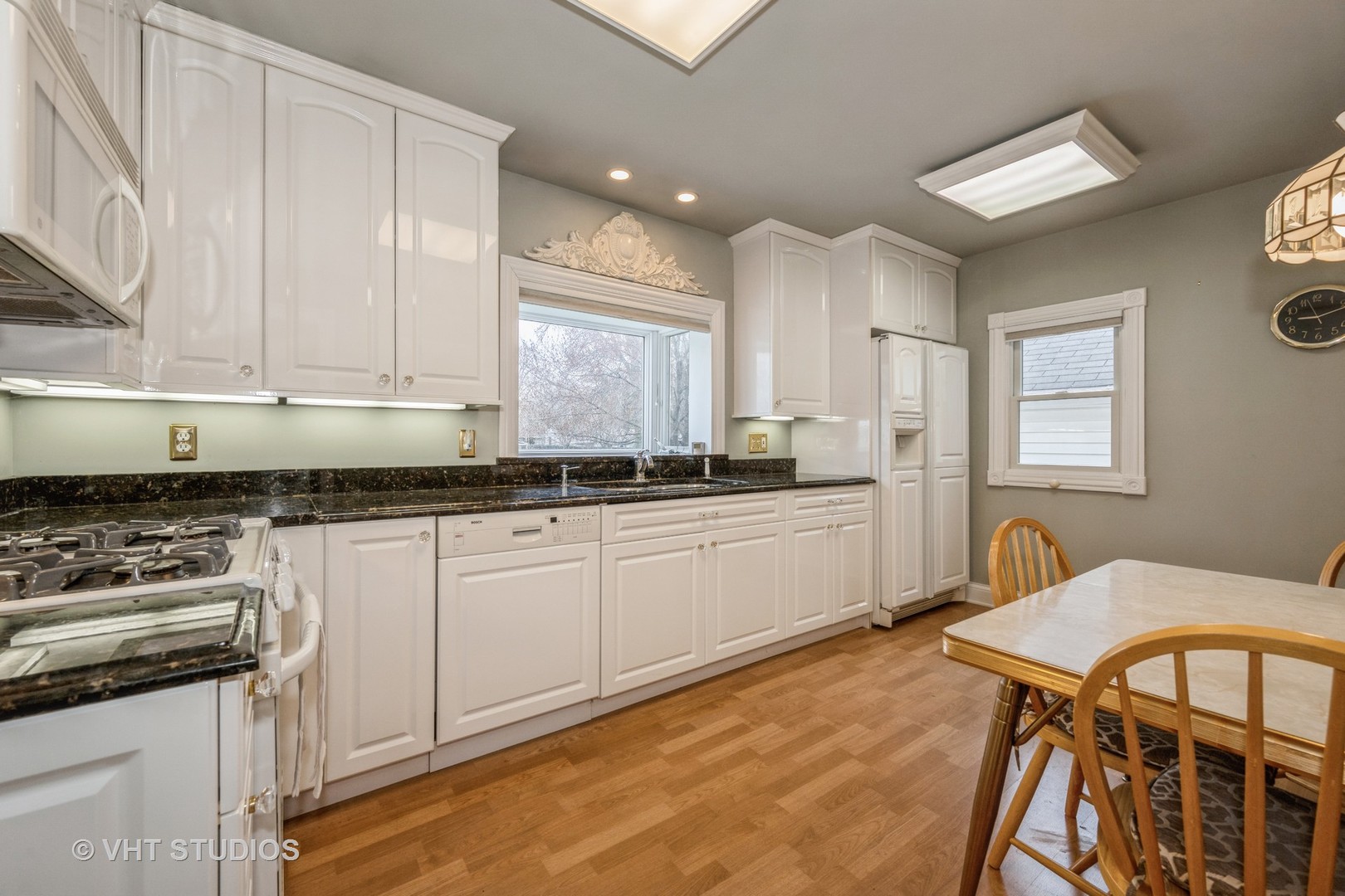 309 East Locust Street Batavia, IL 60510 - Photo 4 of 14 a kitchen with stainless steel appliances granite countertop a stove a sink dishwasher and cabinets