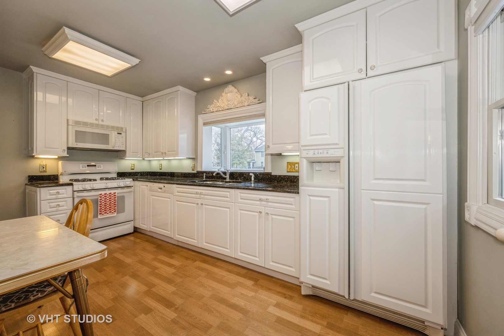 309 East Locust Street Batavia, IL 60510 - Photo 5 of 14 a kitchen with white cabinets and white appliances