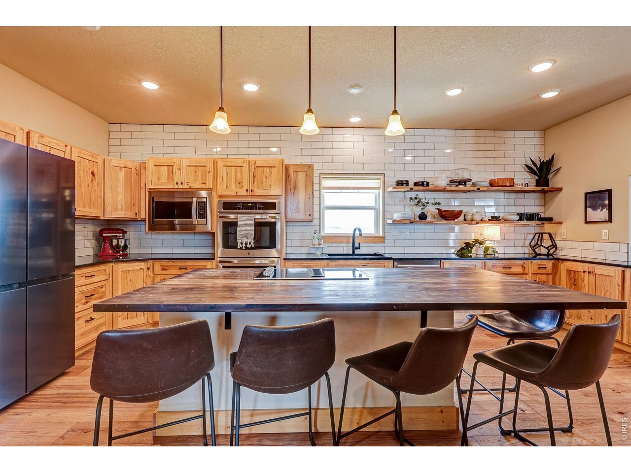 18298 Romar Ranch Road Carr, CO 80612 - Photo 16 of 49 a kitchen with counter and chairs