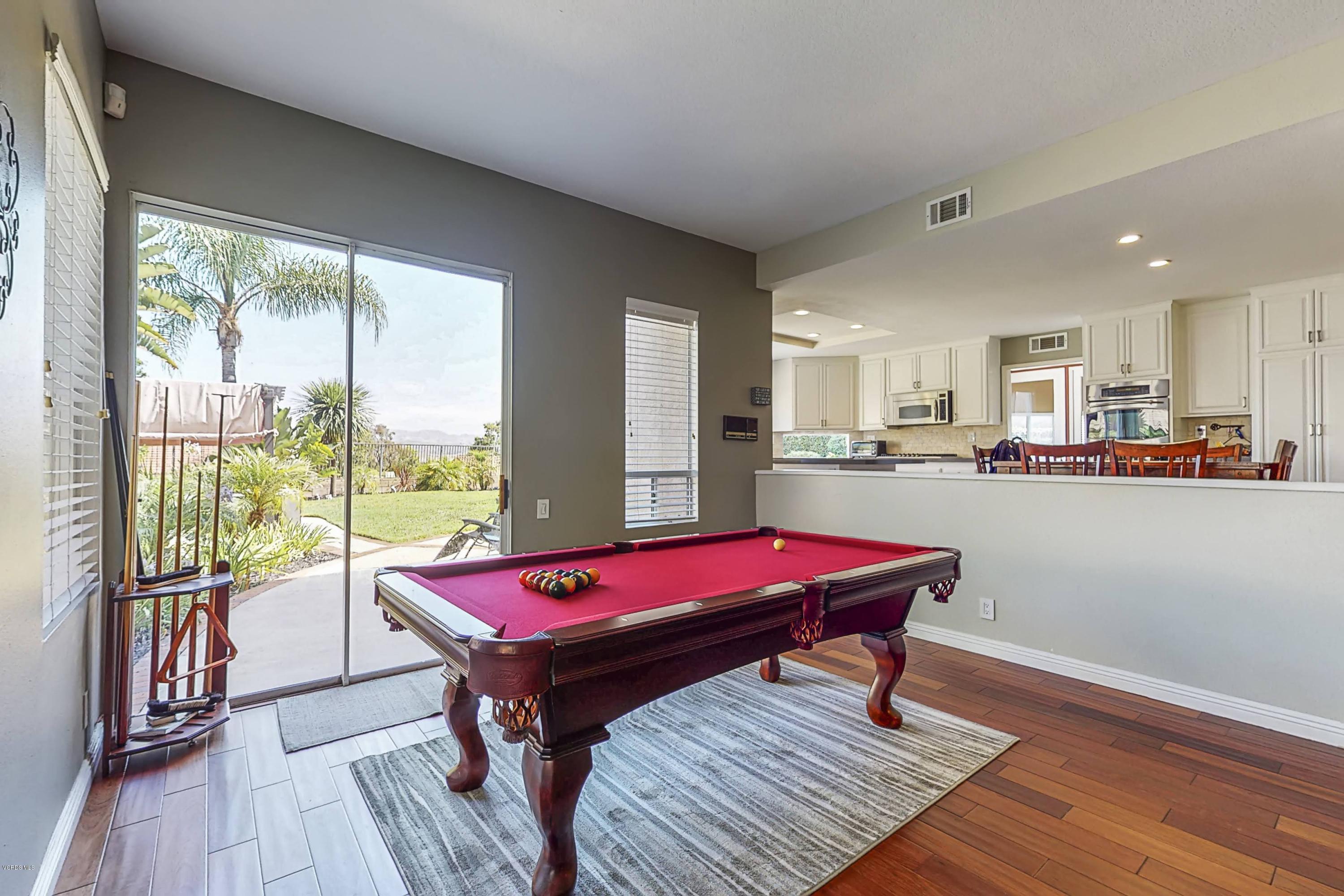 11577 Chestnut Ridge Street Moorpark, CA 93021 - Photo 19 of 58 a large kitchen with a table and chairs with wooden floor