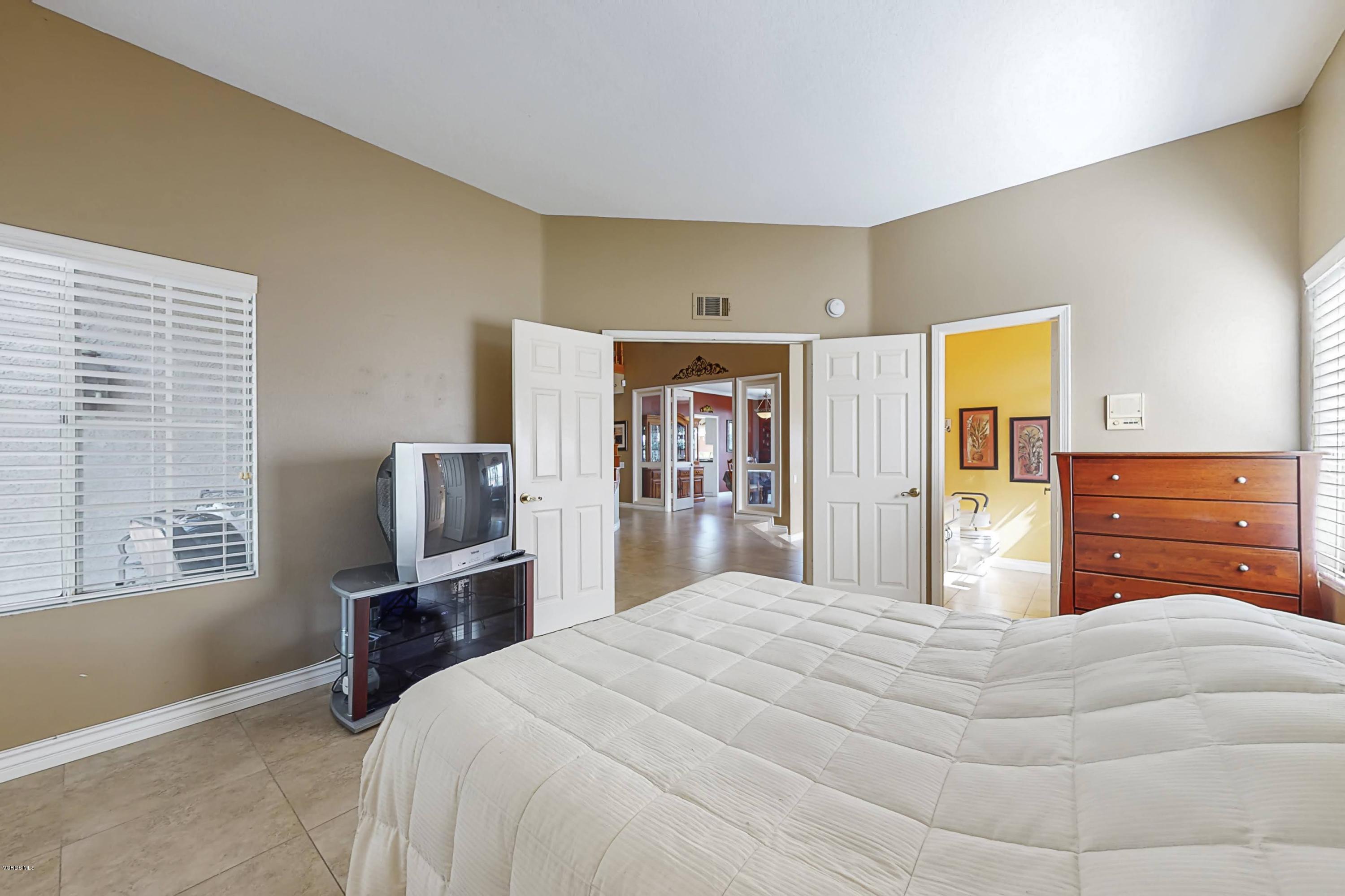 11577 Chestnut Ridge Street Moorpark, CA 93021 - Photo 27 of 58 a bedroom with a bed and wooden floor