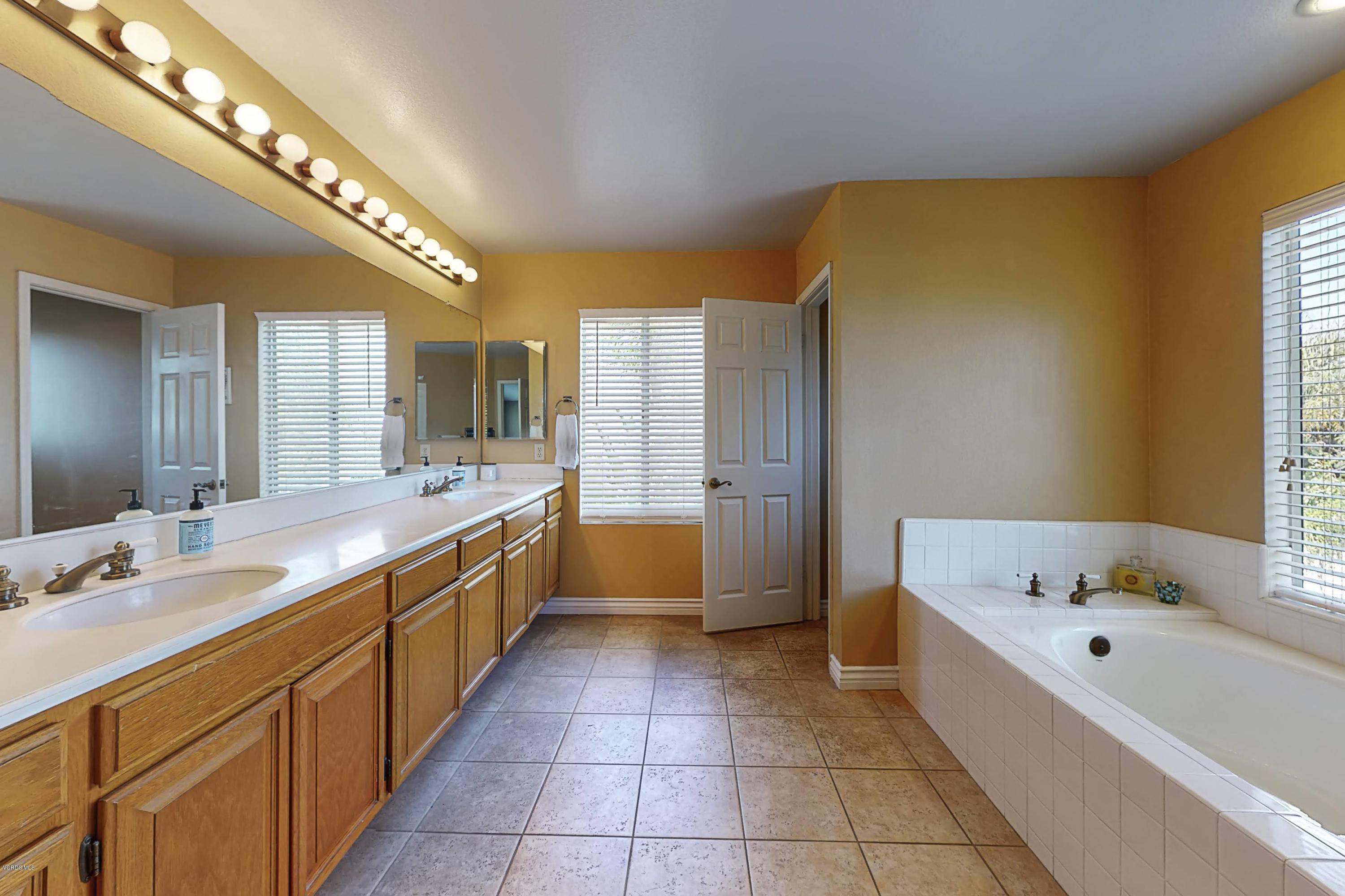 11577 Chestnut Ridge Street Moorpark, CA 93021 - Photo 35 of 58 a large bathroom with a large tub and sink
