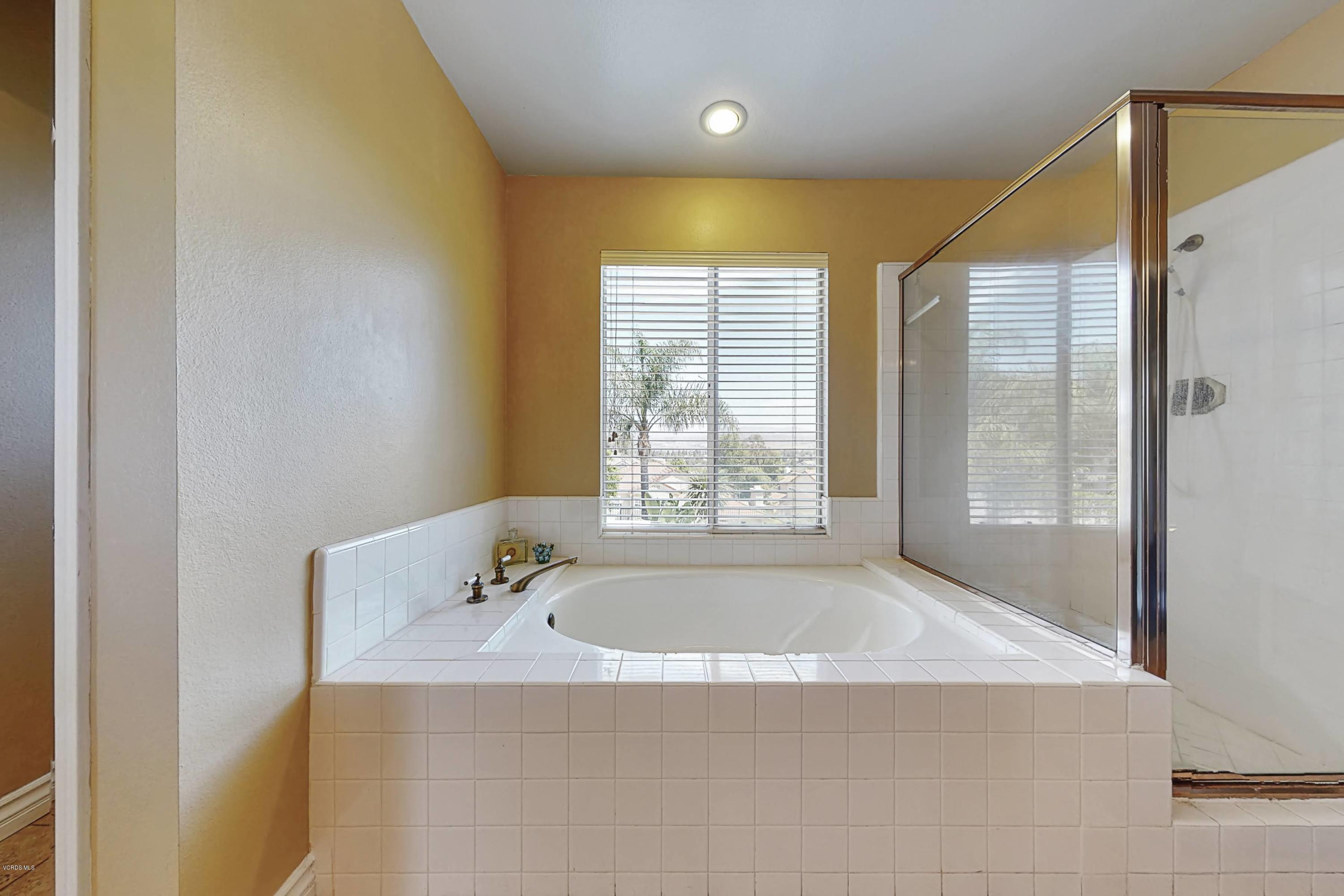 11577 Chestnut Ridge Street Moorpark, CA 93021 - Photo 38 of 58 a bathroom with a tub and shower