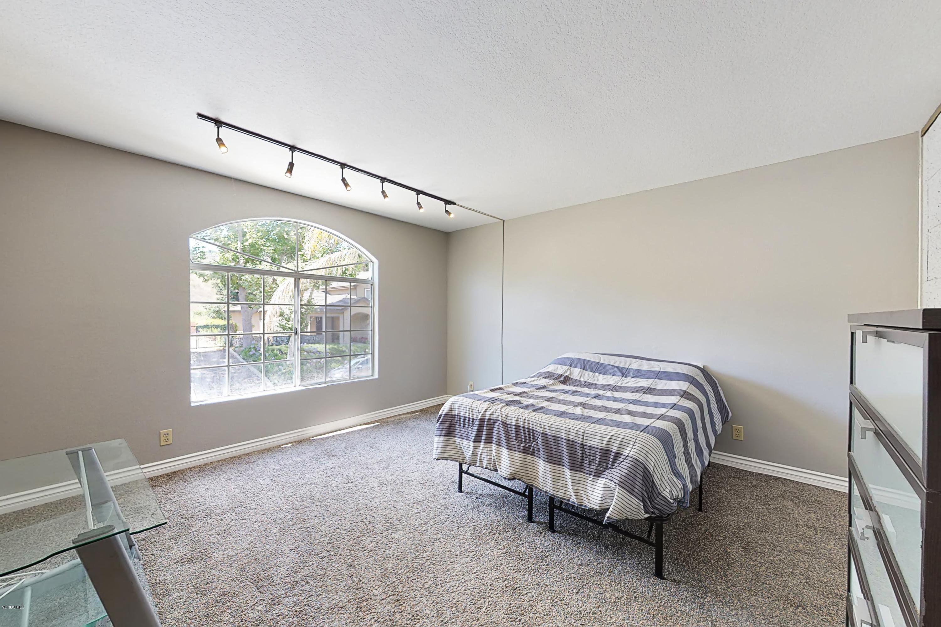 11577 Chestnut Ridge Street Moorpark, CA 93021 - Photo 40 of 58 a bed sitting in a bedroom next to a window