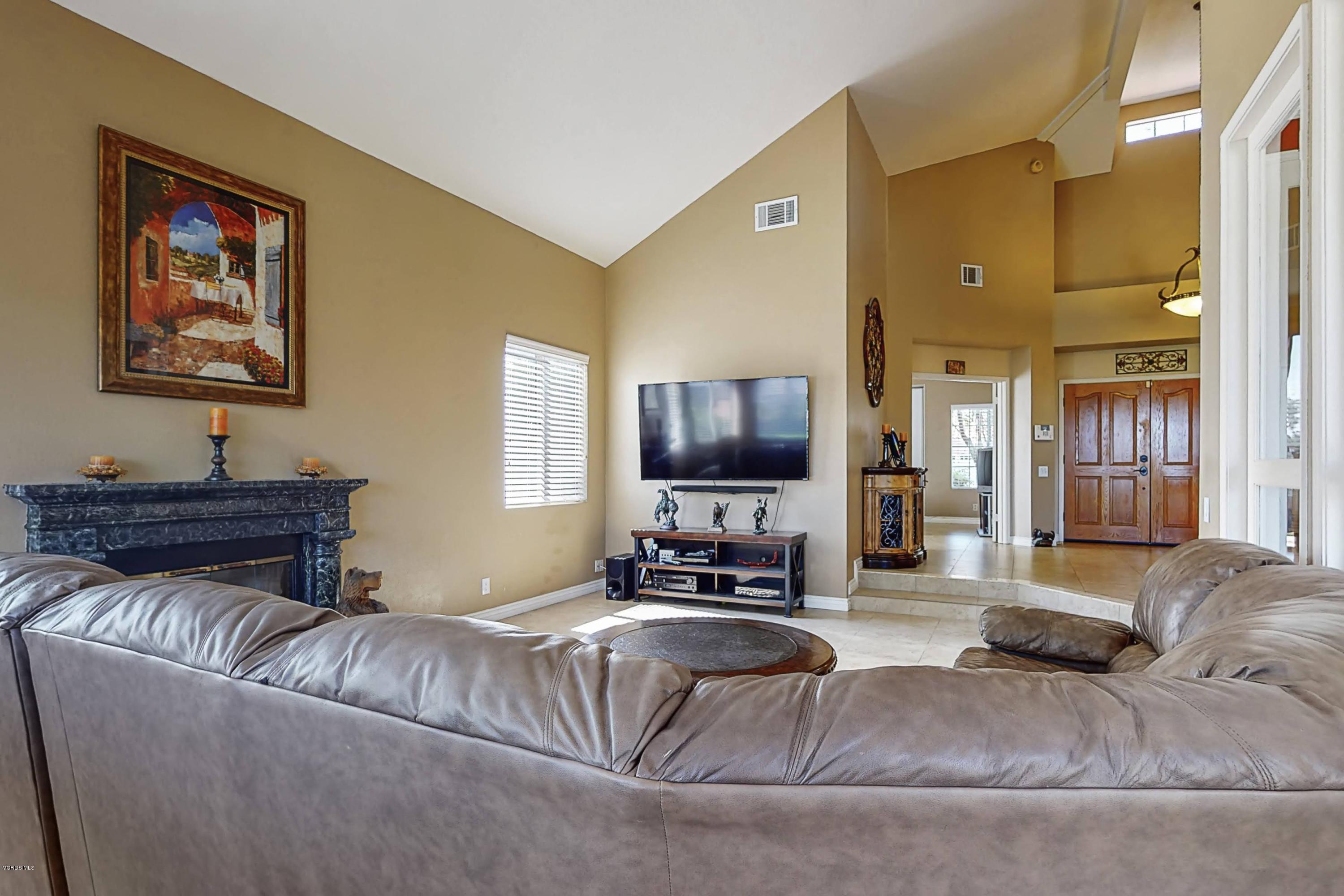11577 Chestnut Ridge Street Moorpark, CA 93021 - Photo 5 of 58 a living room with furniture and a flat screen tv