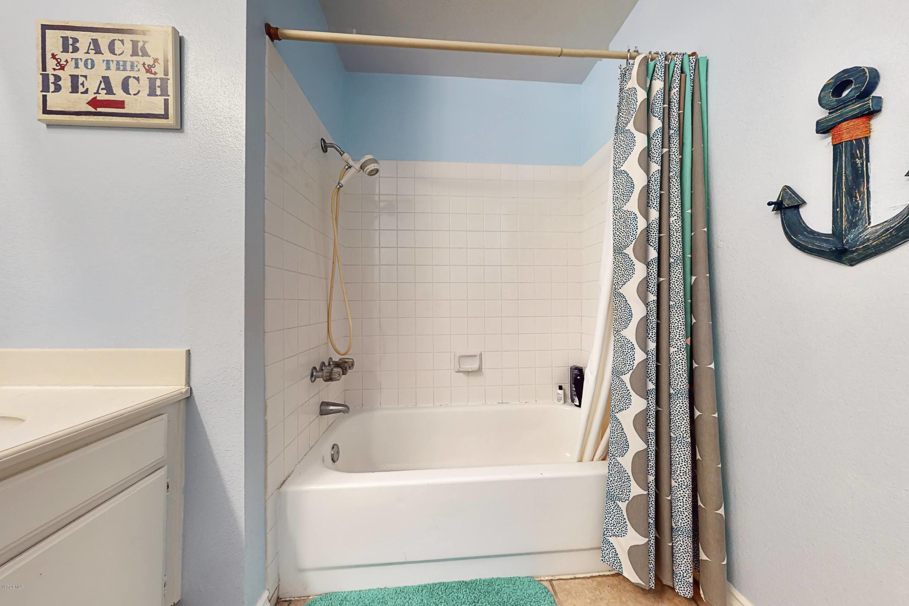 11577 Chestnut Ridge Street Moorpark, CA 93021 - Photo 42 of 58 a bathroom with a tub a sink and a shower