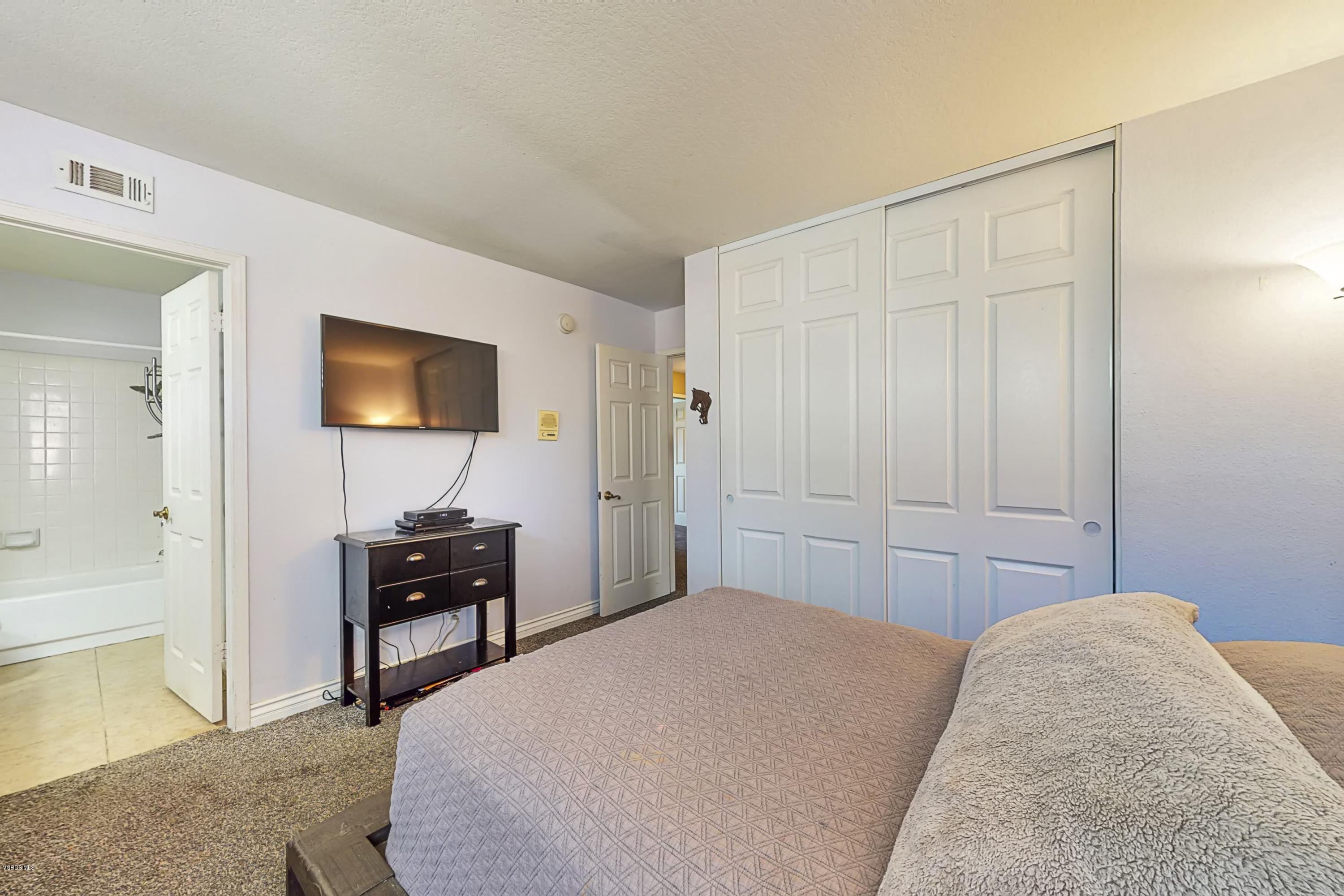 11577 Chestnut Ridge Street Moorpark, CA 93021 - Photo 45 of 58 a bedroom with a bed and a flat screen tv