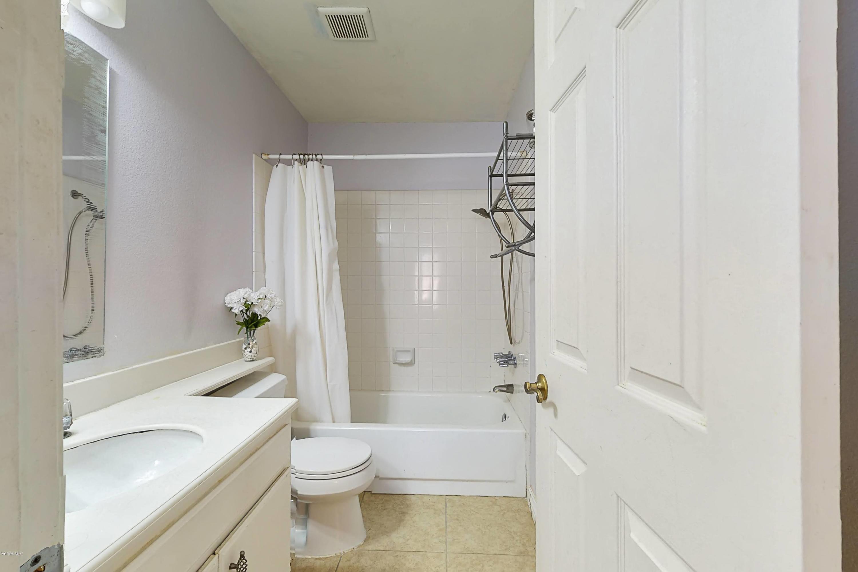 11577 Chestnut Ridge Street Moorpark, CA 93021 - Photo 46 of 58 a bathroom with a granite countertop bathtub shower sink vanity and toilet