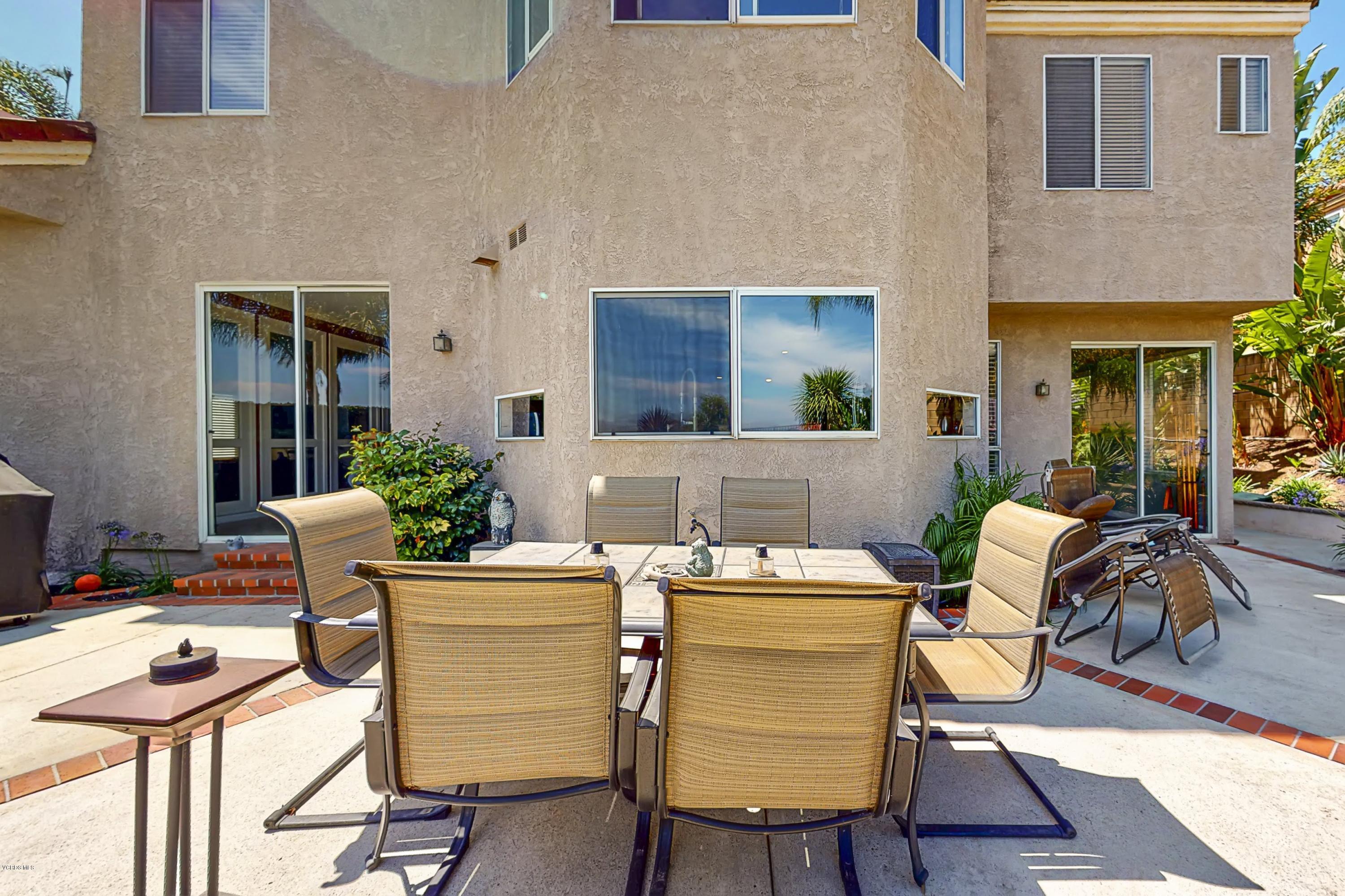 11577 Chestnut Ridge Street Moorpark, CA 93021 - Photo 49 of 58 a view of a patio with table and chairs and potted plants