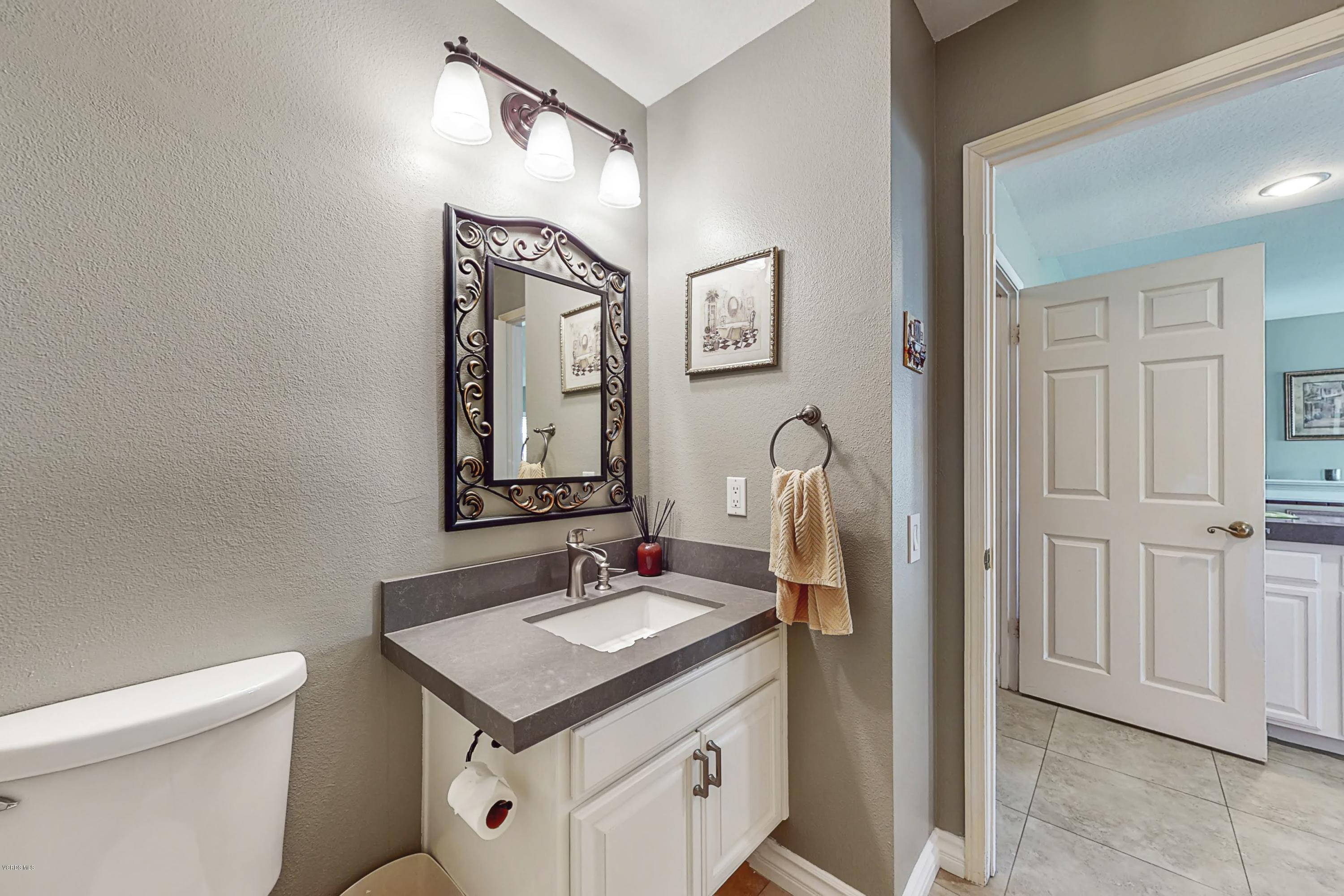 11577 Chestnut Ridge Street Moorpark, CA 93021 - Photo 8 of 58 a bathroom with a sink toilet and mirror