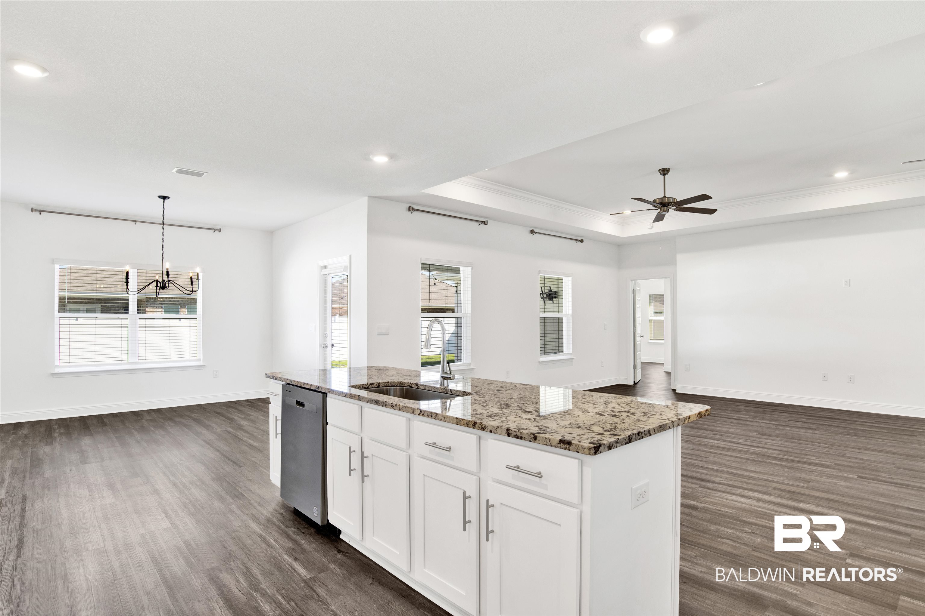 11602 Genuine Risk Circle Daphne, AL 36526 - Photo 30 of 30 Kitchen with open floor plan, white cabinets, light stone countertops, a tray ceiling, and recessed lighting