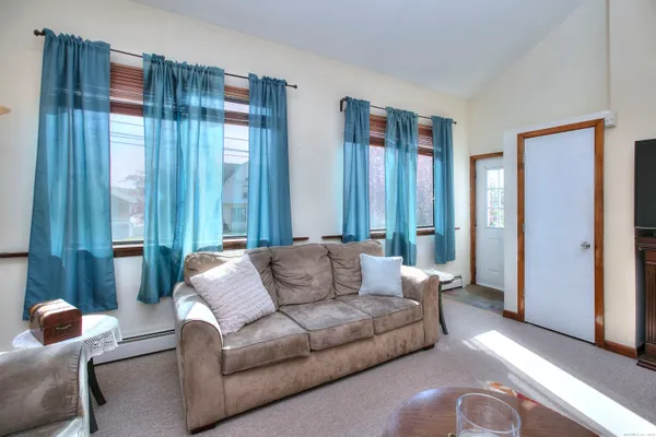 a living room with furniture and large windows