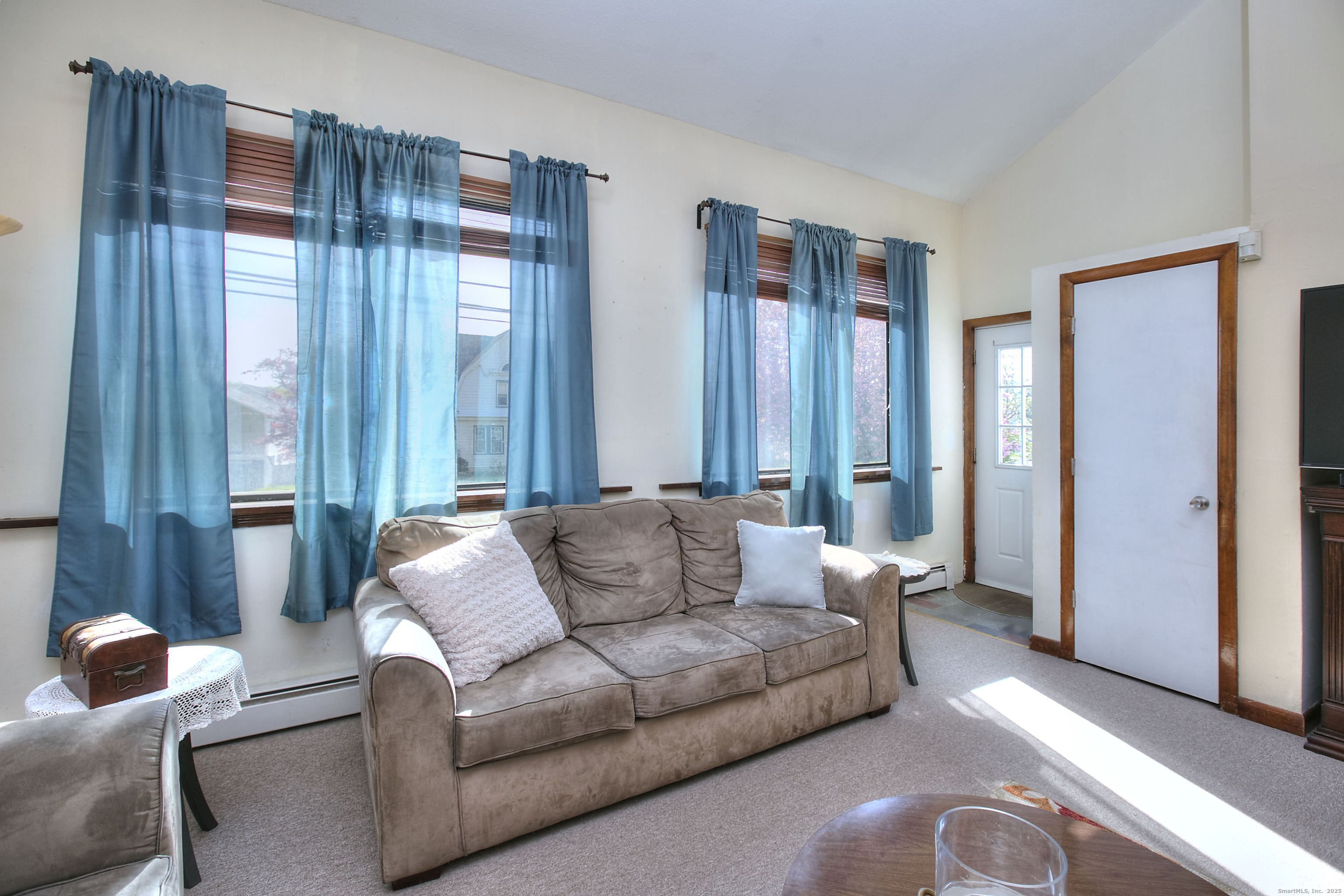 223 River Road Shelton, CT 06484 - Photo 2 of 11 a living room with furniture and large windows