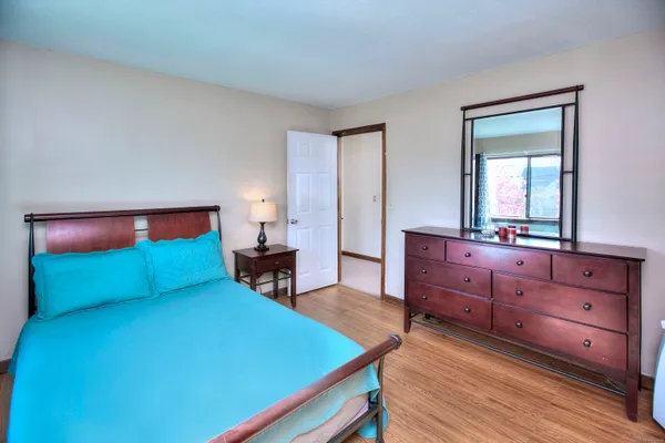 a bedroom with a bed and a dresser