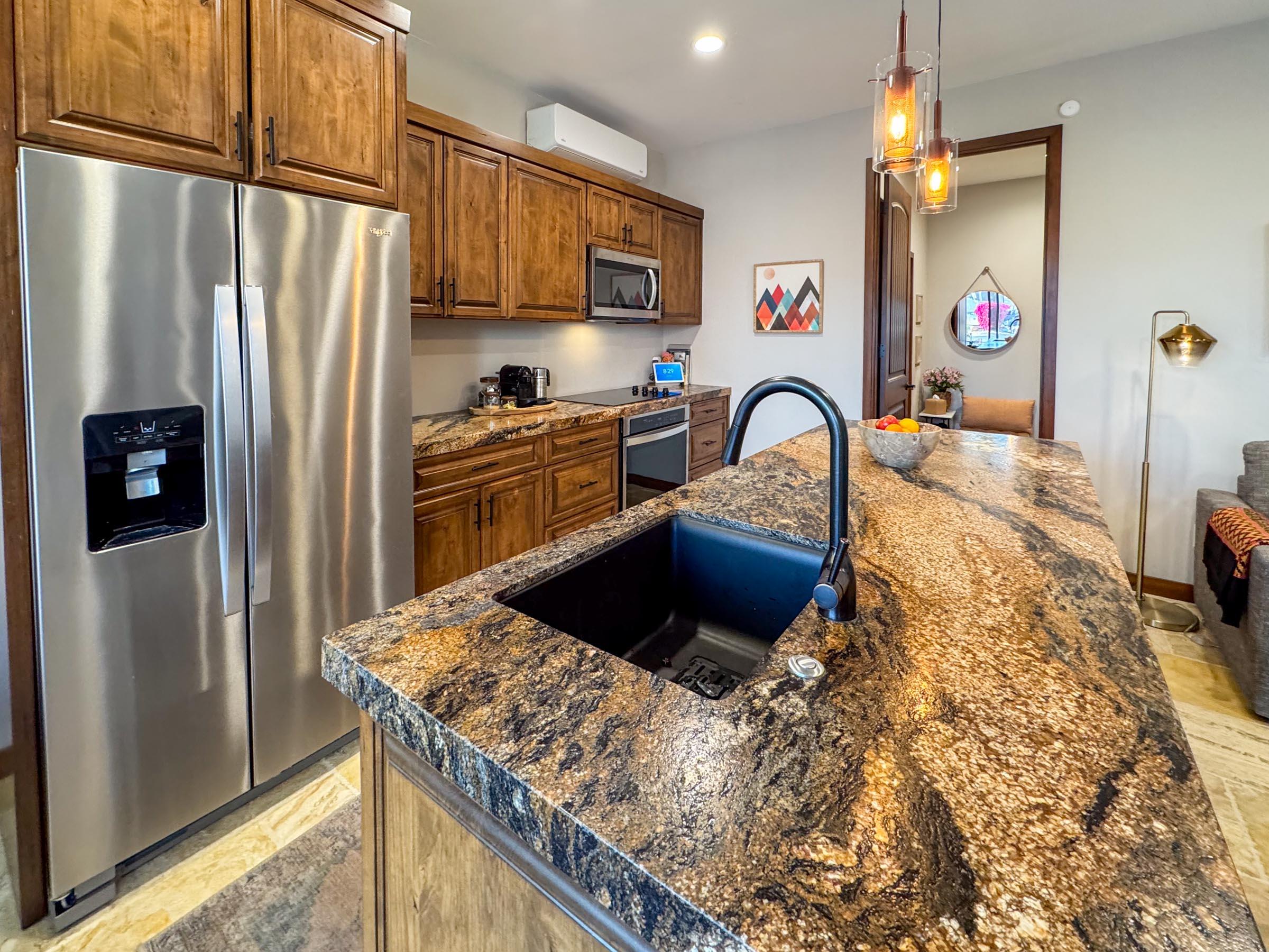 80394 Ave 48, Unit 156 Indio, CA 92201 - Photo 20 of 42 a kitchen with stainless steel appliances granite countertop a refrigerator a stove top oven a sink and dishwasher