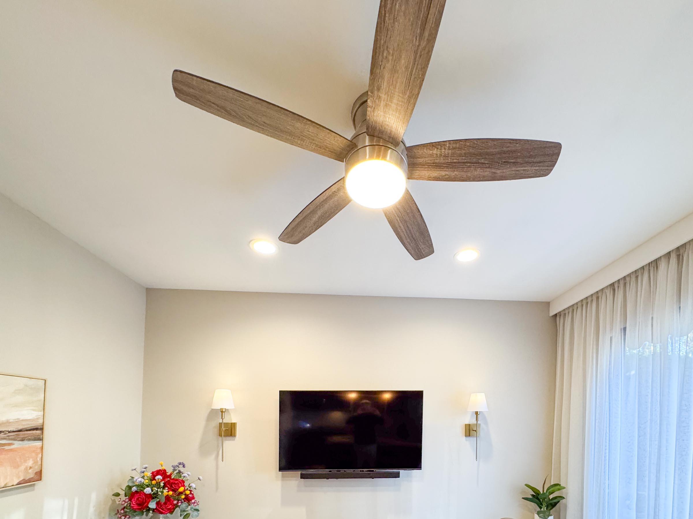 80394 Ave 48, Unit 156 Indio, CA 92201 - Photo 30 of 42 a living room with a flat screen tv and a chandelier