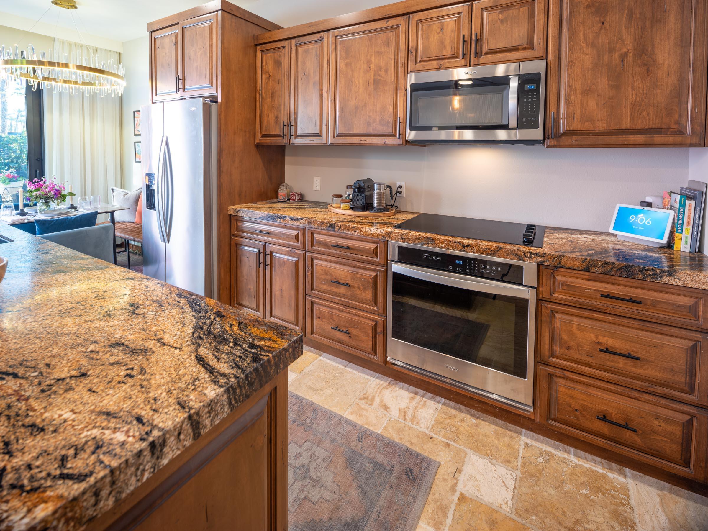 80394 Ave 48, Unit 156 Indio, CA 92201 - Photo 3 of 42 a kitchen with stainless steel appliances granite countertop a stove top oven microwave and refrigerator