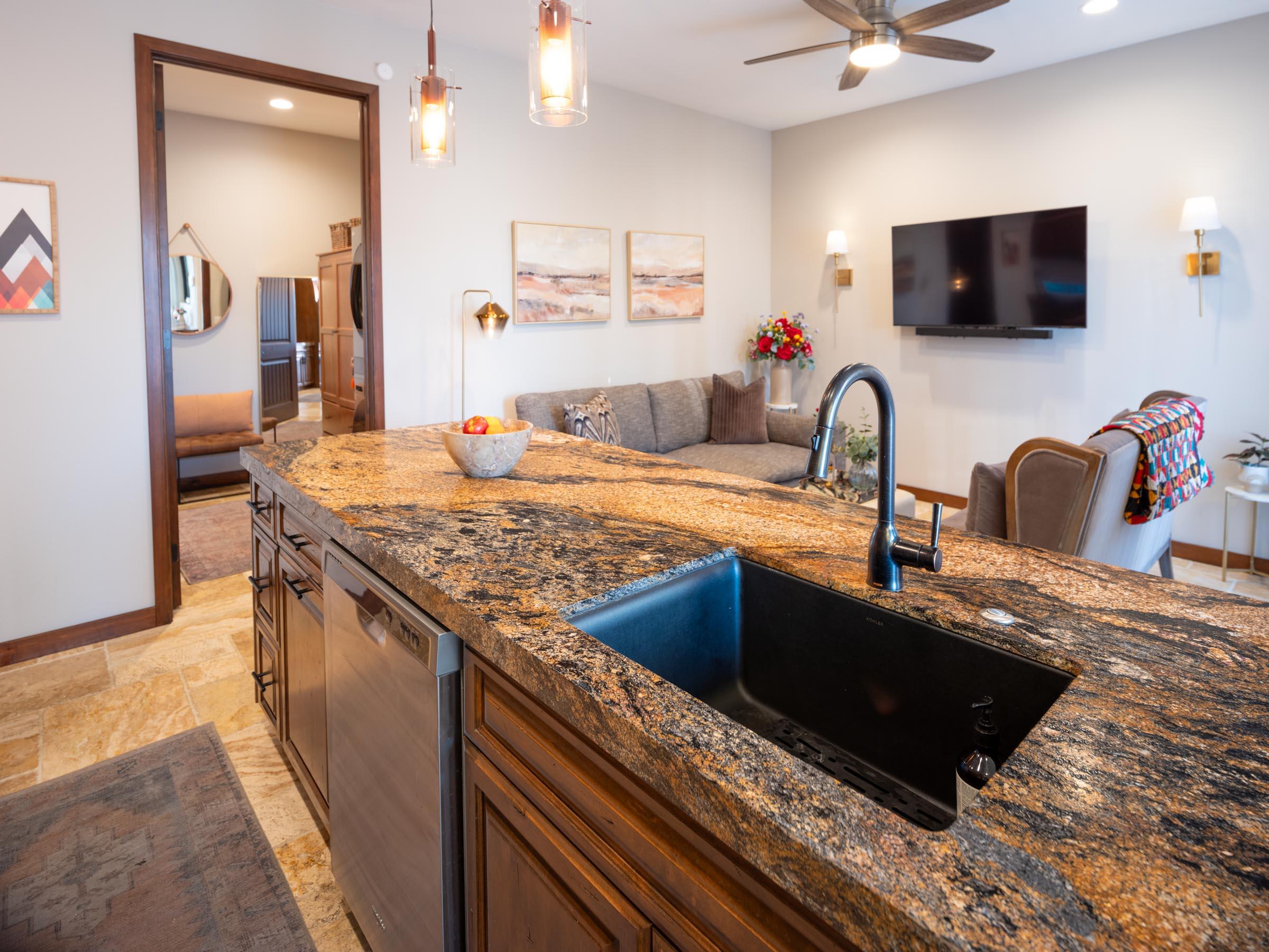 80394 Ave 48, Unit 156 Indio, CA 92201 - Photo 5 of 42 a kitchen with stainless steel appliances granite countertop a sink a stove top oven a granite counter space and cabinets