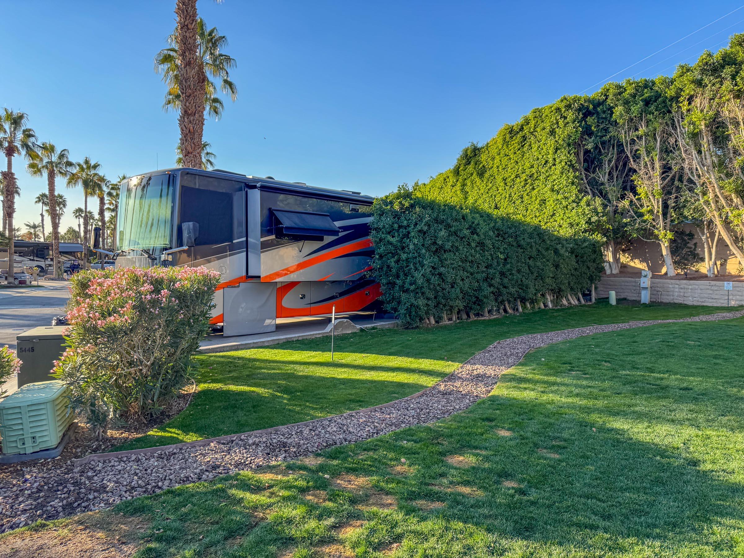 80394 Ave 48, Unit 156 Indio, CA 92201 - Photo 6 of 42 a front view of a house with a yard and potted plants